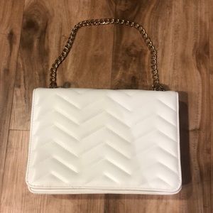 White purse with gold hardware